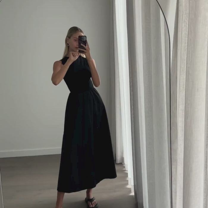 Female model online wearing black high neck sleeveless princess cut midi dress 